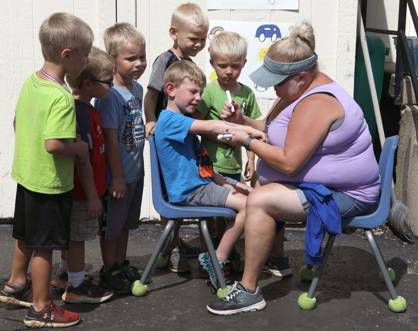 Ms. Michele paints Jameson Tobben's arm